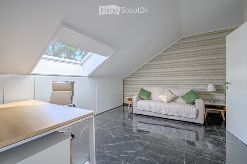 Furnished Room. A modern office space with a desk, office chair, and a couch with pillows. The room has a marble floor and a skylight window.
