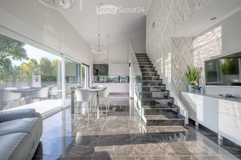 Furnished Room. Modern open-plan living and dining area with marble flooring, glass doors, and a staircase.