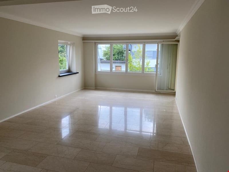 Empty room with light-colored walls, large windows, and a polished tile floor. No furniture or equipment is present.