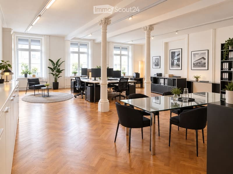 Modern office space with wooden flooring, large windows, multiple desks with office chairs, computer monitors, printers, glass meeting table, chairs, potted plants, lamps, and picture frames on the walls.