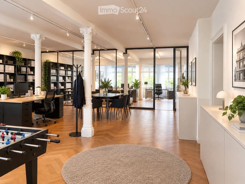 Modern office space with wooden flooring, large glass partitions, multiple desks, chairs, a football table, bookshelves, lamps, and plants.