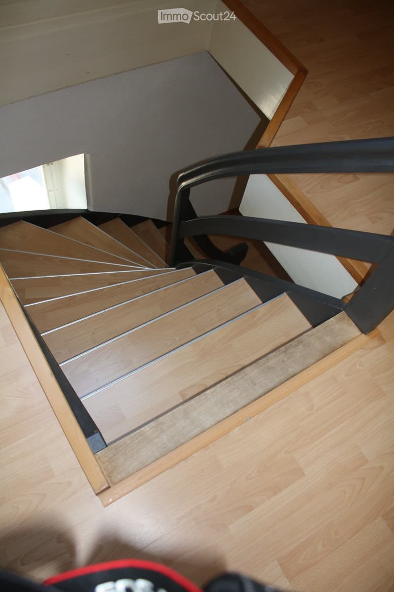 interior stairs with wooden steps and black railing