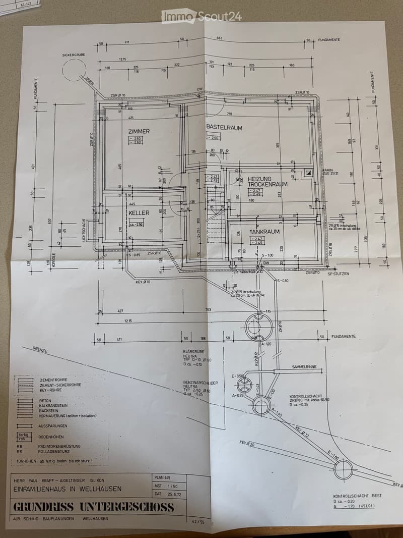 Floor plan of a basement level showing rooms including a cellar, heating drying room, tank room, and basement space. Includes dimensions, structural elements, and technical annotations.