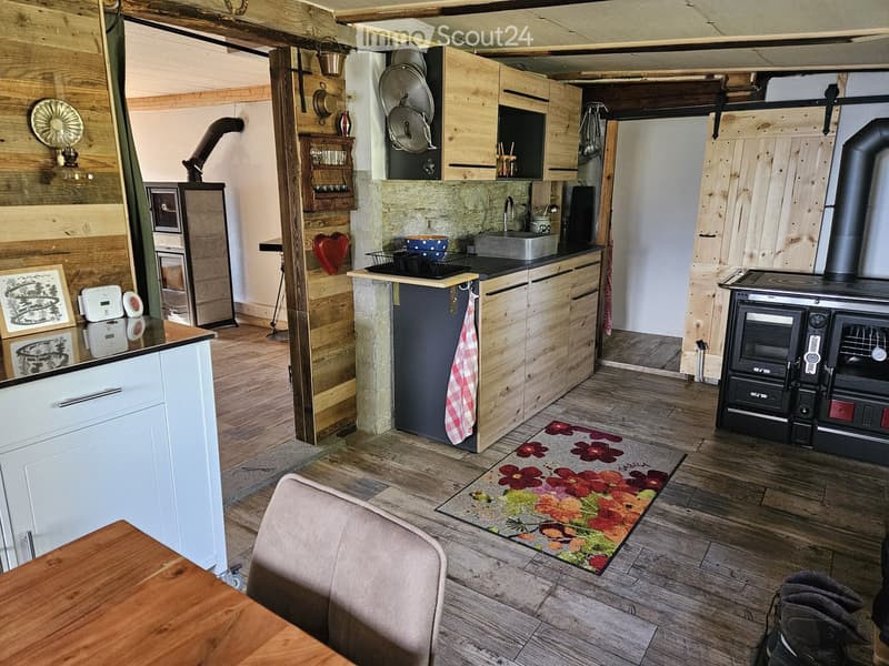 {"type": "Furnished Room", "objects": ["wooden table", "sofa", "wooden cabinets", "sink", "faucet", "oven", "fridge", "oven", "fridge", "fridge", "oven", "oven", "oven", "oven", "oven", "oven", "oven", "oven", "oven", "oven", "oven", "oven", "oven", "oven