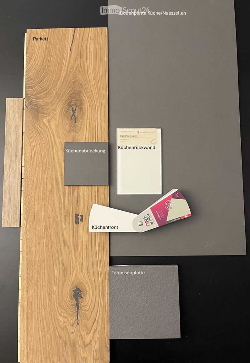 Display of various flooring and kitchen material samples including parquet, kitchen backsplash, kitchen front, kitchen tiles, and terrace tiles.