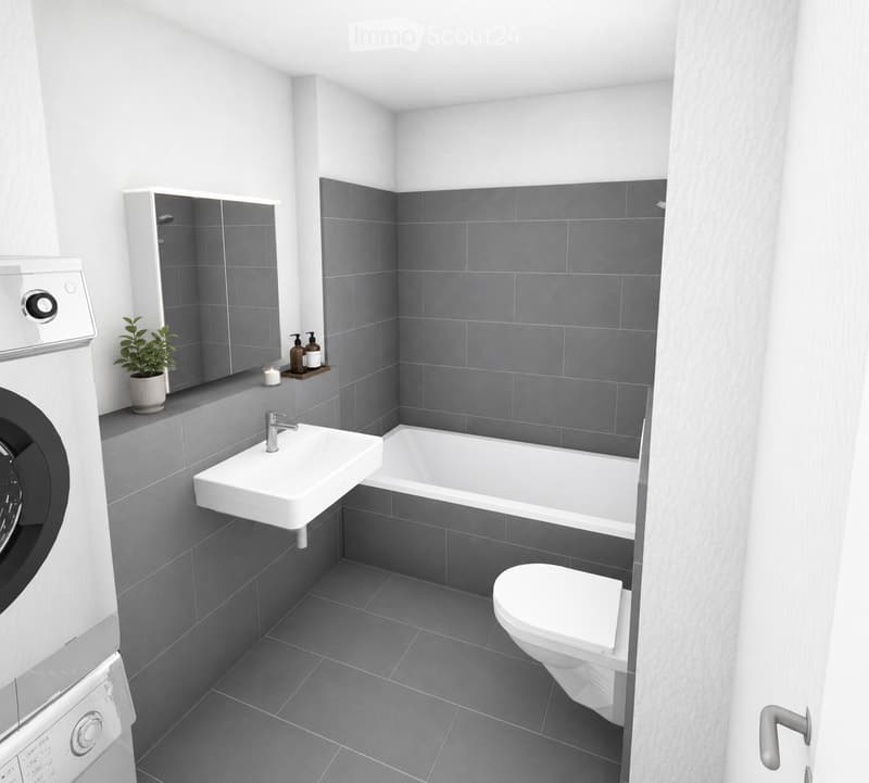 Modern bathroom with grey tiles, white fixtures, a sink, bathtub, toilet, mirror, washing machine, candle, and small plant on the windowsill.