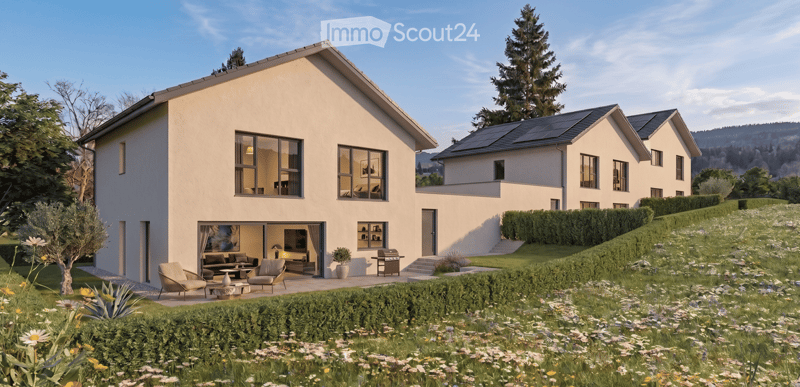Modern two-story house with light-colored exterior, large windows, and a spacious garden area with seating and a grill.