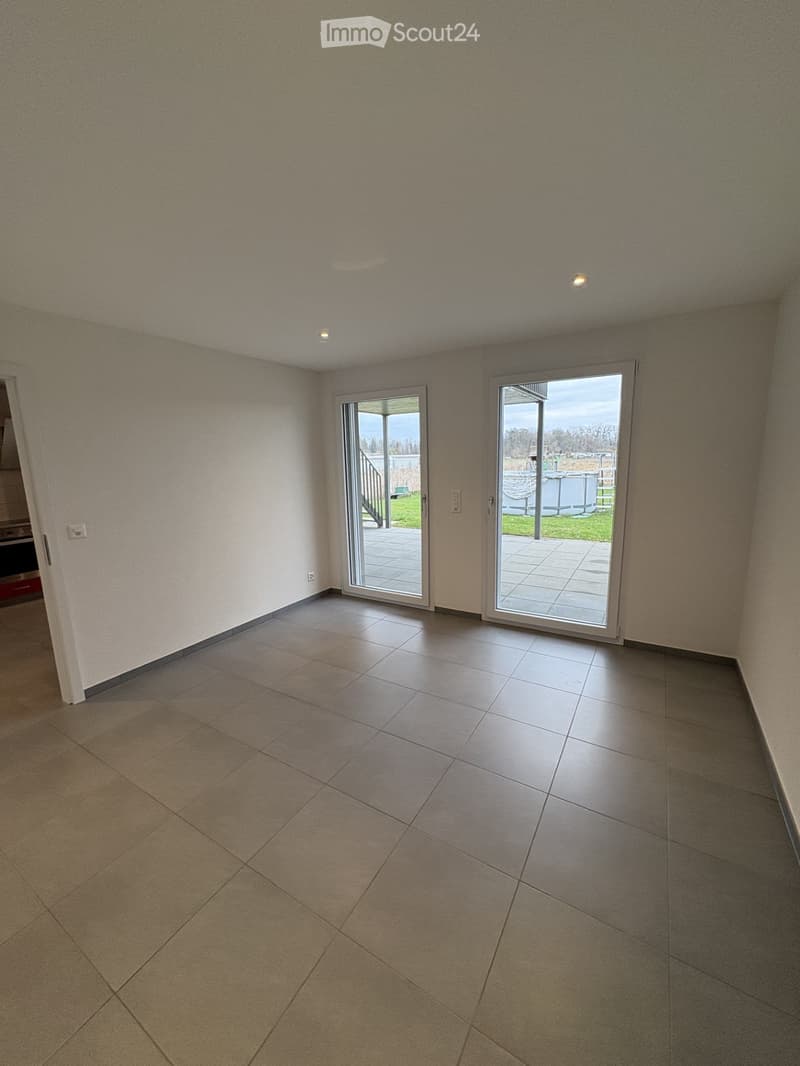 empty room, white walls, gray tiles, sliding glass doors, balcony outside