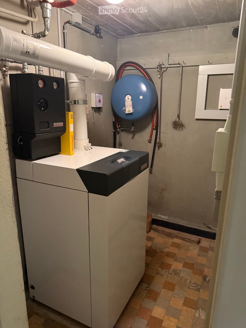 Utility room with water heater, boiler, pressure vessel, and control panel.