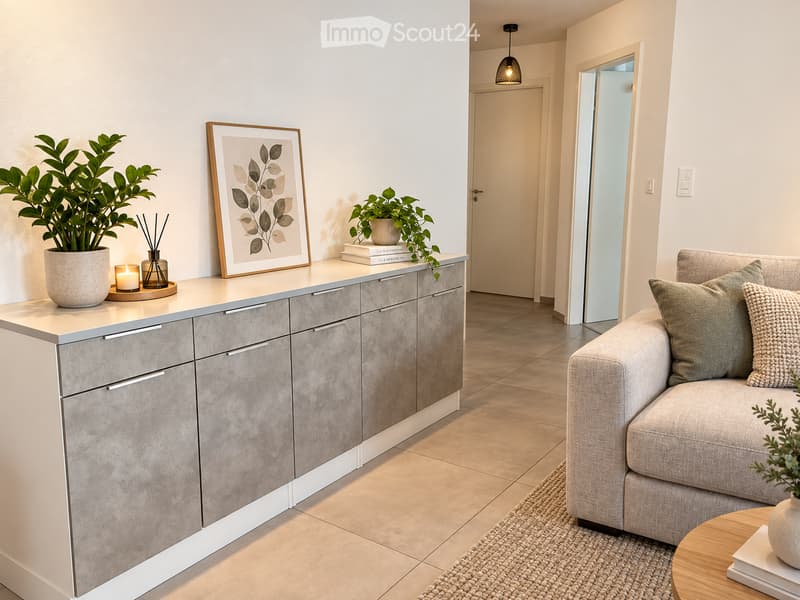 Modern living room with a grey sofa, wooden coffee table, grey cabinet, potted plants, and decorative items on the cabinet.