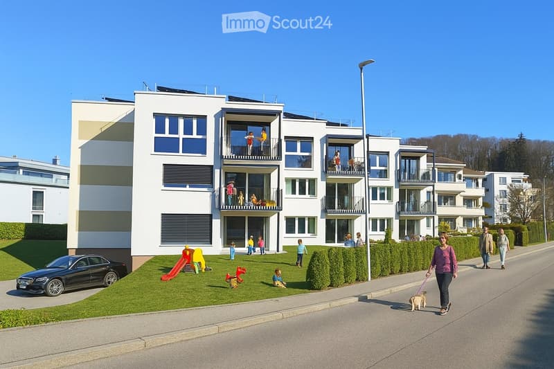 Modern apartment building with solar panels, balconies, and a playground in front