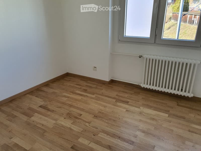 empty room, white walls, wooden floor, white radiator, windows