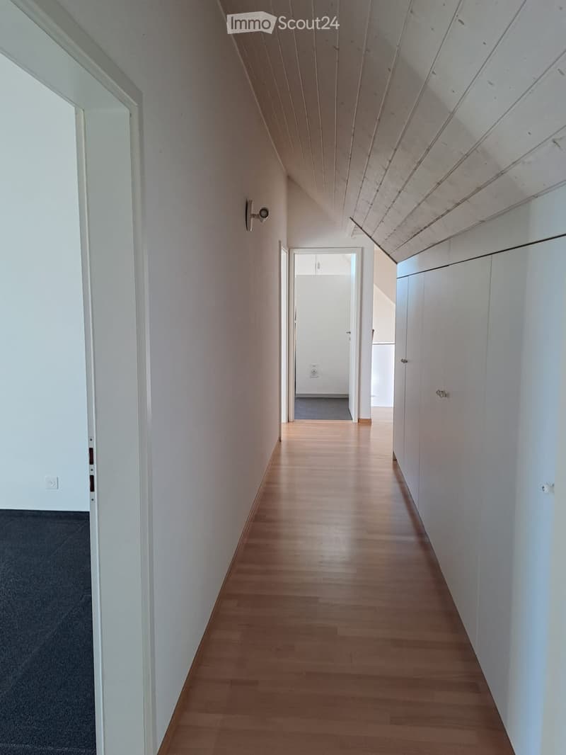 hardwood floor, white walls, white ceiling, two doors, built-in storage
