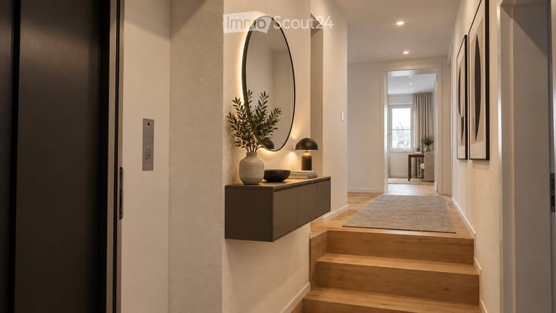 Modern hallway with wooden stairs, a small console table with a vase and bowl, a round mirror with built-in lighting, and a lamp on the table.