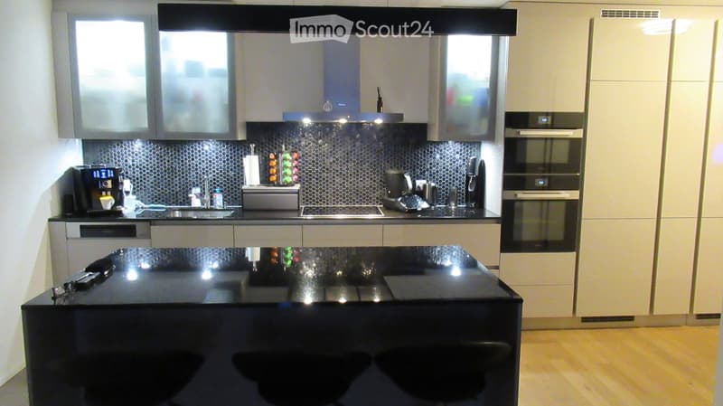 modern kitchen, black countertops, white cabinets, stainless steel appliances, black stools