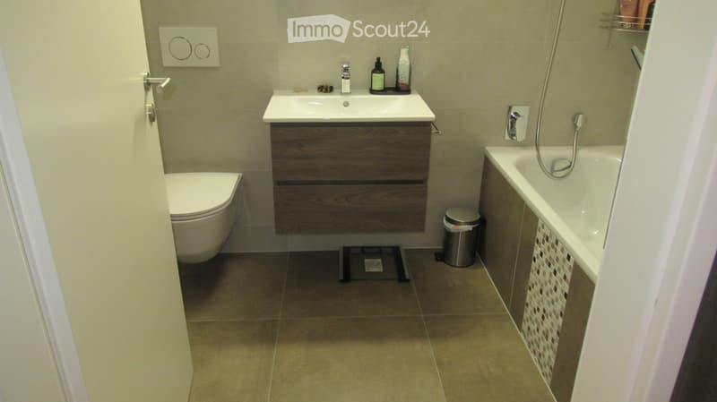 modern bathroom with white toilet, white bathtub, white sink, tiled floor, wall-mounted power outlets