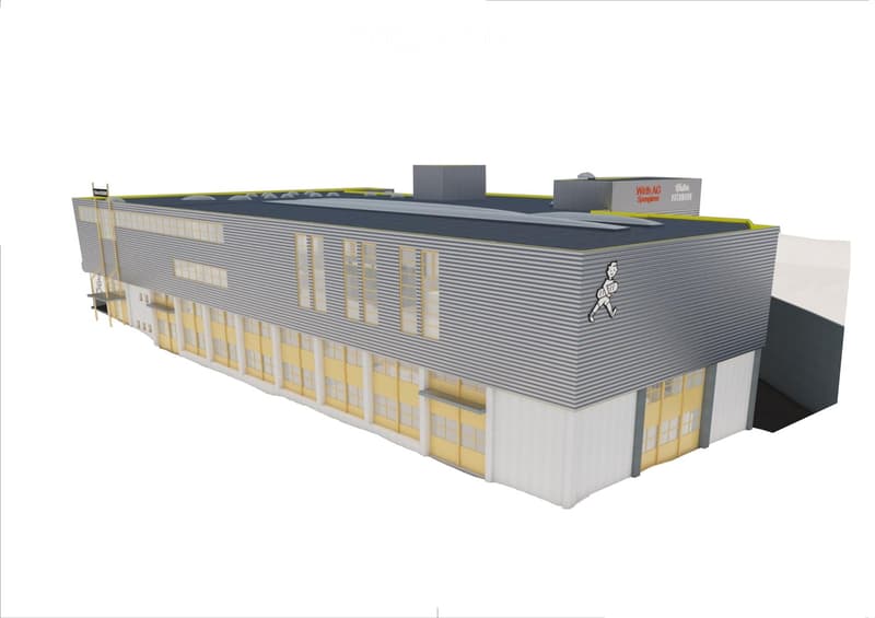large building with windows, yellow doors, gray walls and roof, chimneys, name on the side