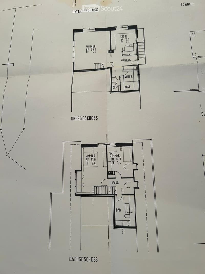 Floor plan showing three levels: basement with living room, kitchen, and bathroom; upper level with two bedrooms and hallway; attic level with additional space.