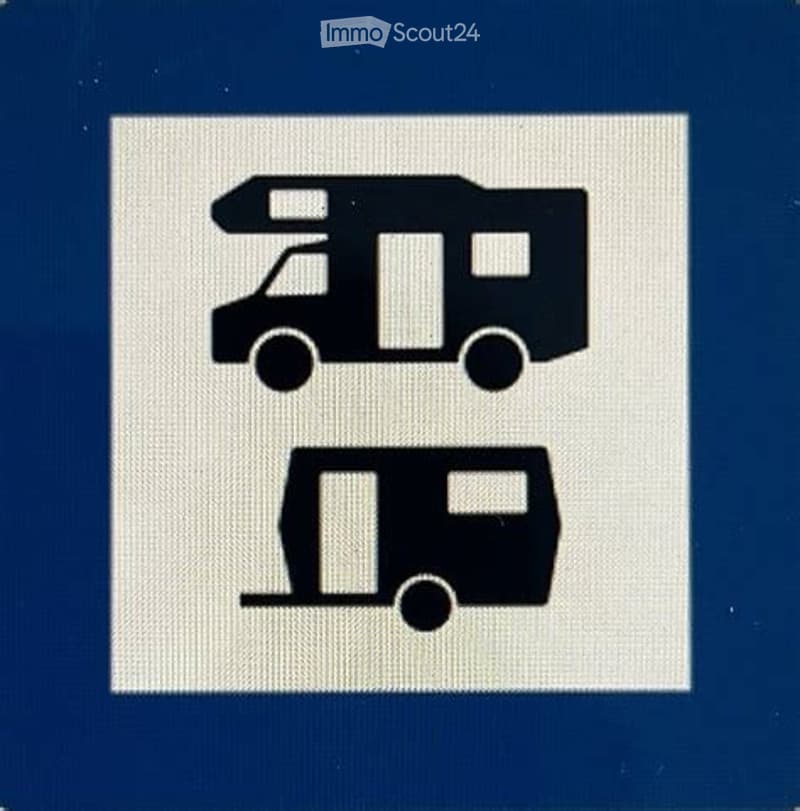 Sign indicating parking for caravans and motorhomes, with two caravan symbols.