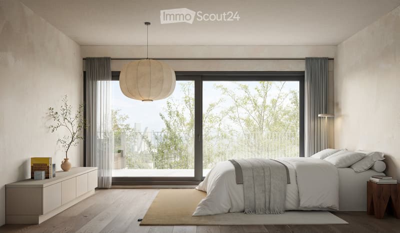 A bedroom with sliding glass doors leading to a balcony, large bed, white bedding, gray curtains, a large window, hanging lamp, wooden bedside table with books, wooden cabinet with books and a plant