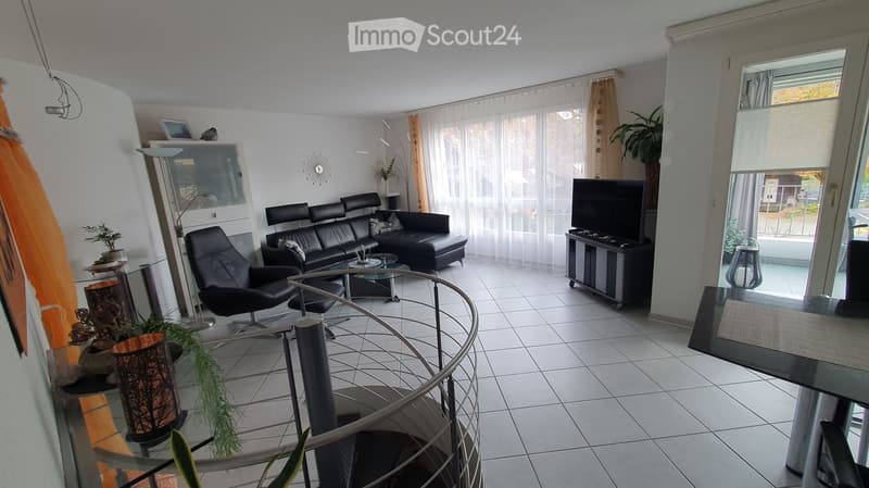 modern apartment, leather sofa, glass table, TV, spiral staircase, white tiles, plants, open balcony
