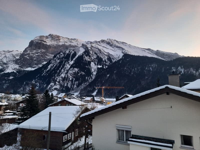 snowy mountains, houses, construction site, crane, snow-covered roofs