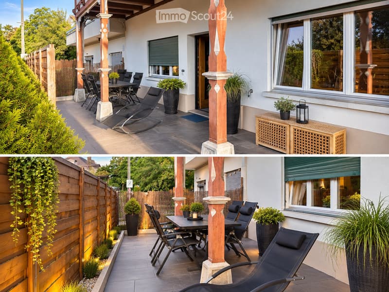 Outdoor patio area with wooden fence, lounge chairs, dining table, potted plants, and decorative lighting.