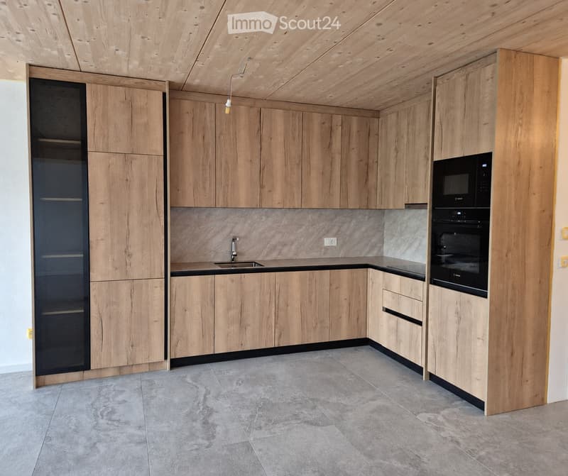 Modern kitchen with light wood cabinets, stainless steel appliances, and a sleek design.