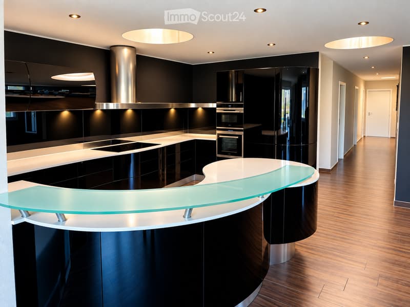 Modern kitchen with black cabinetry, white countertops, a sleek glass island, and built-in ovens.