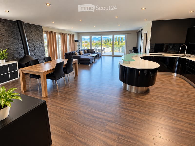 Open-plan living and dining area with modern furniture, wooden flooring, large windows offering a scenic view, and a sleek kitchen island.