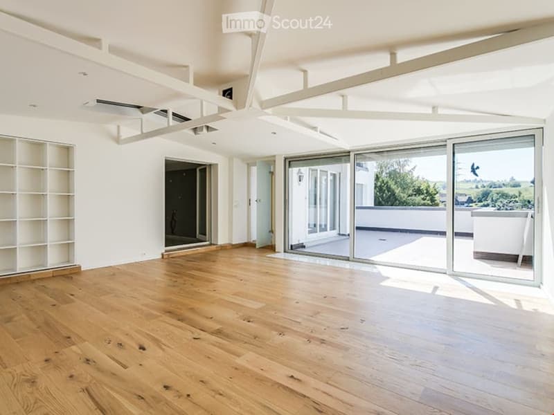 spacious room, hardwood floors, sliding glass doors, balcony, white walls, modern fixtures