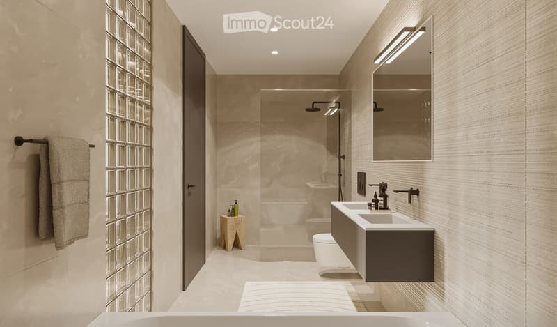 Modern bathroom with beige tiles, double sink, large mirror, glass shower enclosure, and a small wooden stool holding toiletries.