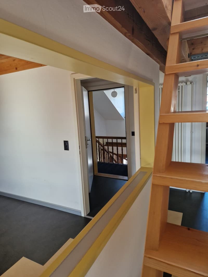 wooden ladder, entrance door, wooden staircase, gray flooring, open doorway