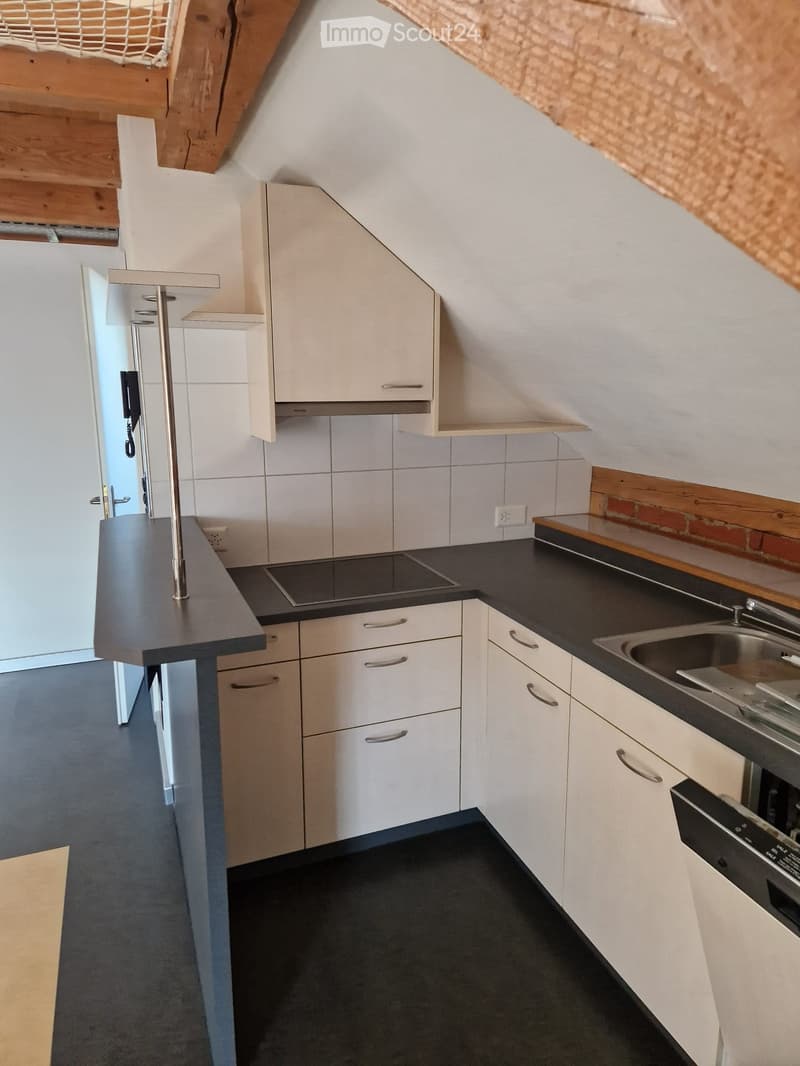 White cabinets, tiled walls, gray countertop, electric stove, sink, dishwasher, open doorway