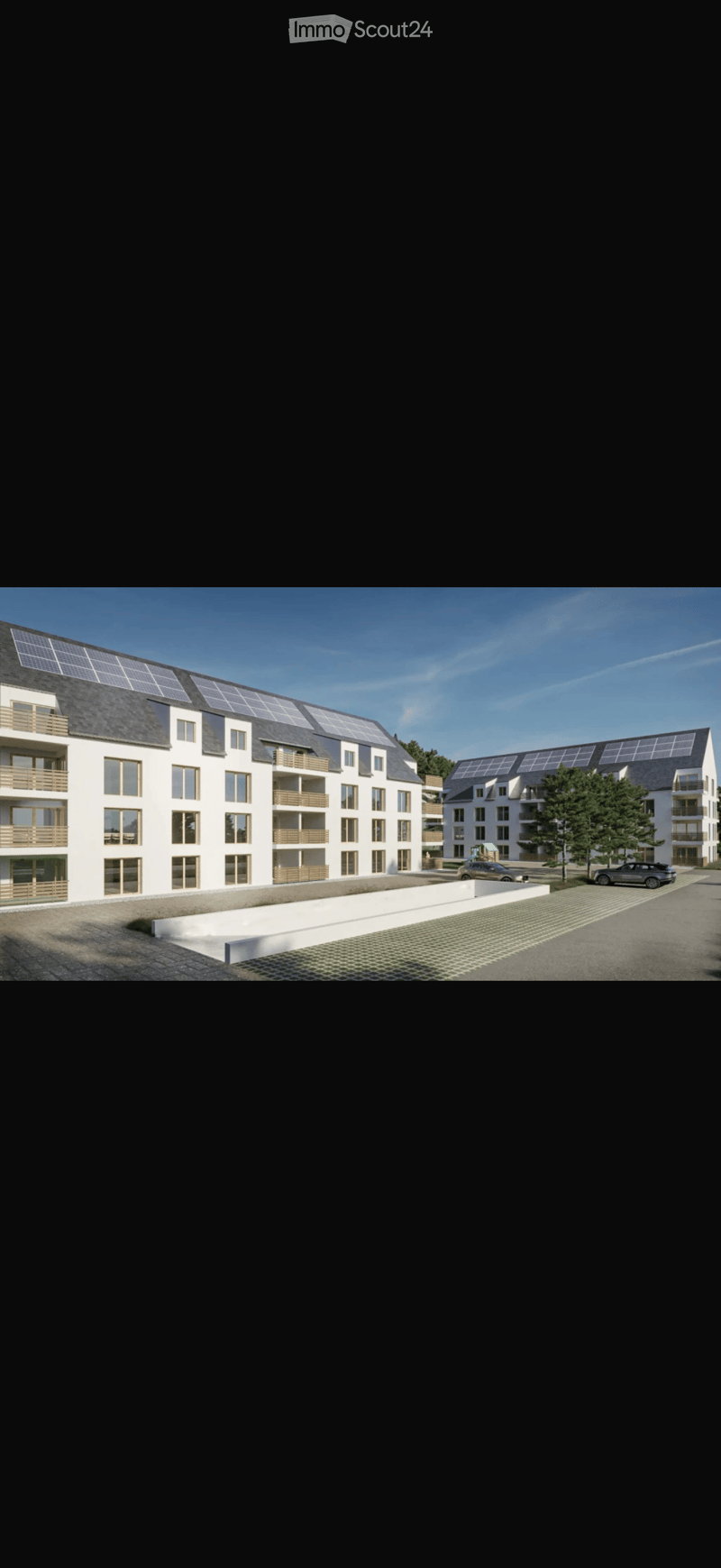 Modern multi-story residential building with balconies, solar panels on the roof, and a paved parking area.