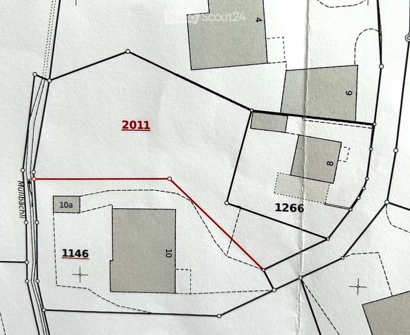 Floor plan showing multiple plots and structures with labeled sections and boundaries.