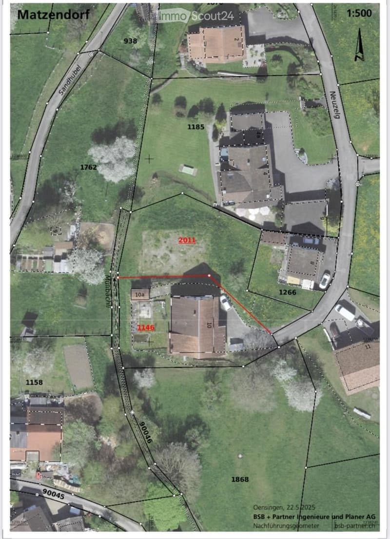 A detailed aerial map showing property boundaries, road networks, and multiple buildings in a rural area. The map includes labeled plots and a scale of 1:500.