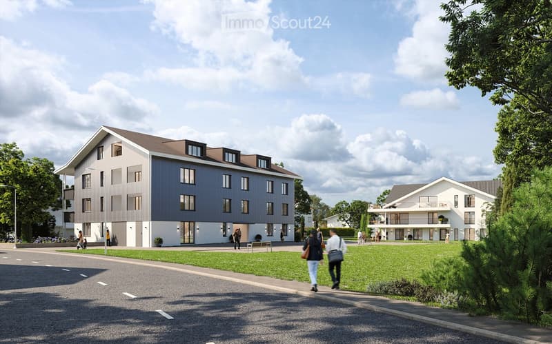 A modern residential complex with a mix of apartment buildings and townhouses, surrounded by green spaces and trees.