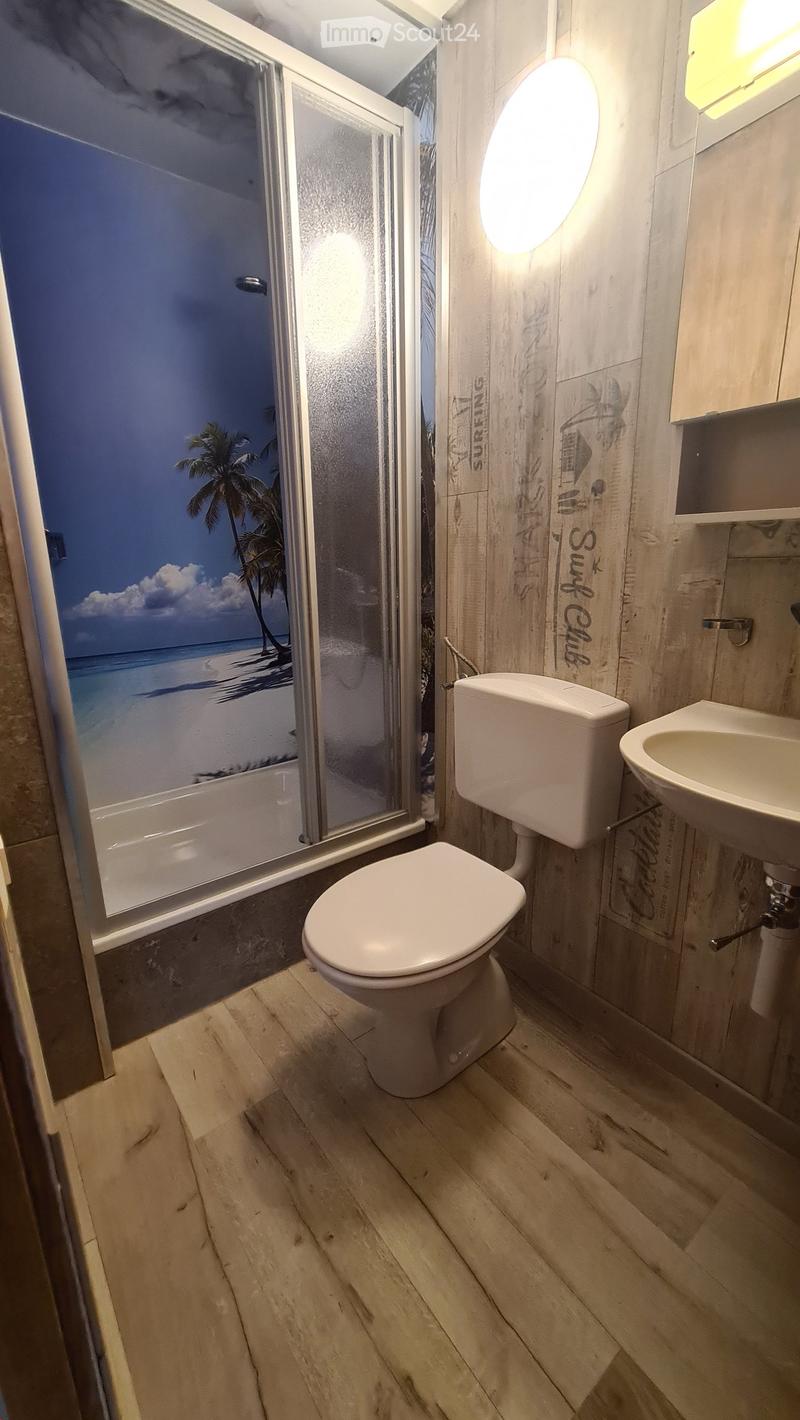 Bathroom with shower, sink, and toilet