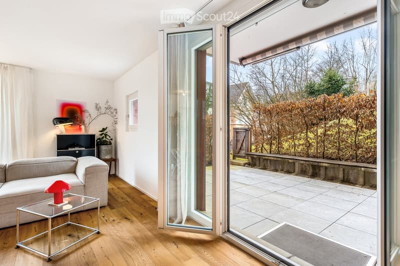 grey couch, glass table, floor lamps, patio doors, wooden floor