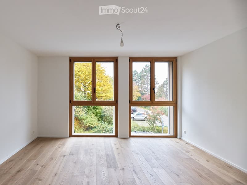 empty room, two large windows, hardwood floors, high ceiling, exterior view to the garden