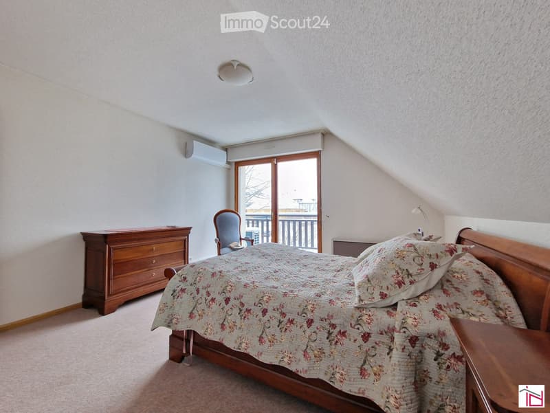 bedroom with bed, night stand, chair, dressing table, balcony, air conditioning