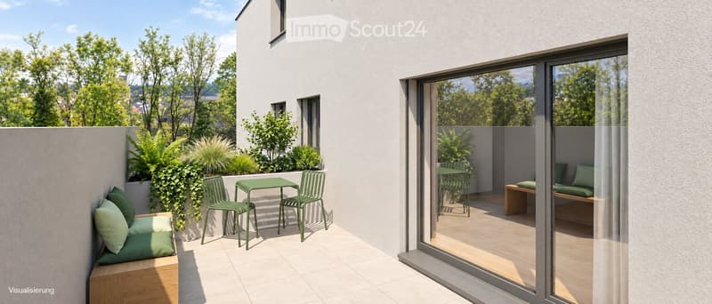 Modern balcony with green furniture, a small table, chairs, a bench with cushions, and lush greenery, overlooking a scenic view.
