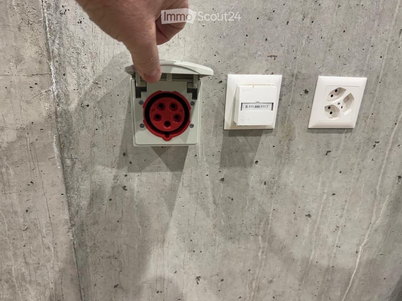 White electrical outlets mounted on a concrete wall