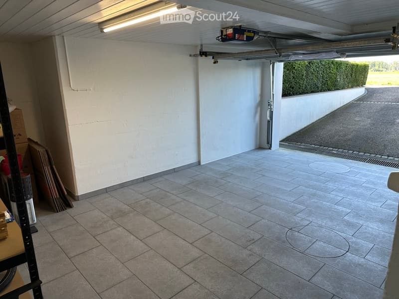 tiled floor, white walls, ceiling light, open door, car access