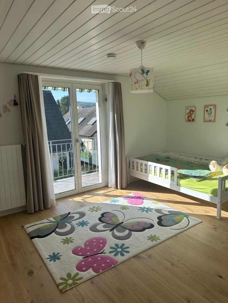 wooden floor, white bed, butterfly rug, curtains, balcony, view of roof