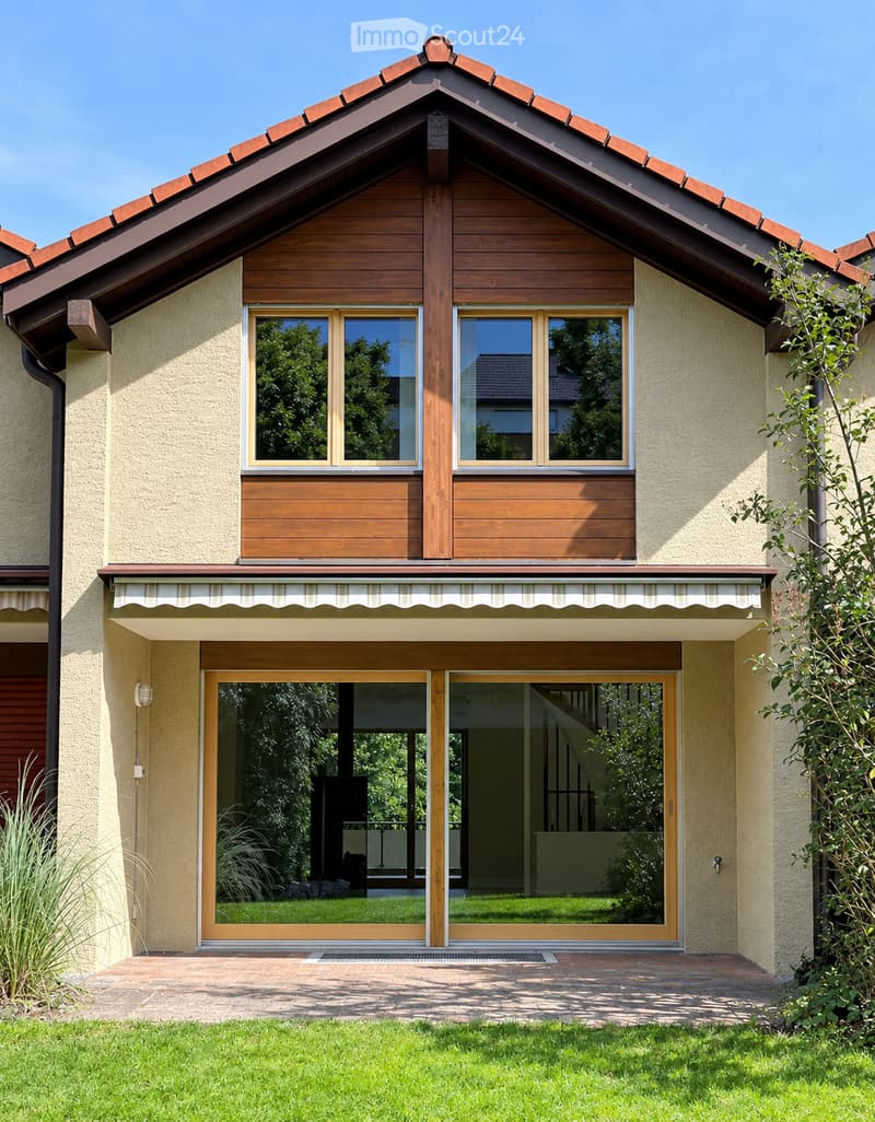 Two-story house with a red-tiled roof, wooden accents, large windows, and a covered entrance with sliding glass doors.