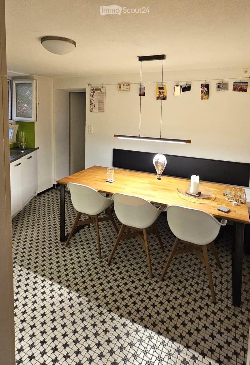 4 chairs, dining table, patterned tiles, overhead ceiling lamp, wall decor