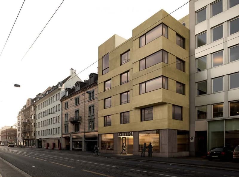 Modern multi-story building with large windows and a sleek facade, located on a city street with other historic buildings nearby.