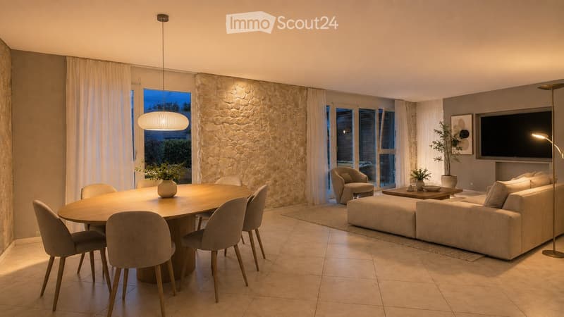 Modern living and dining area with a stone accent wall, large windows, a round wooden dining table with six chairs, a beige sectional sofa, a coffee table, a pendant light, and a television mounted on the wall.